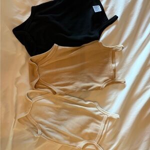 Set of Three Baby Bodysuits in Black, Tan, and Cream